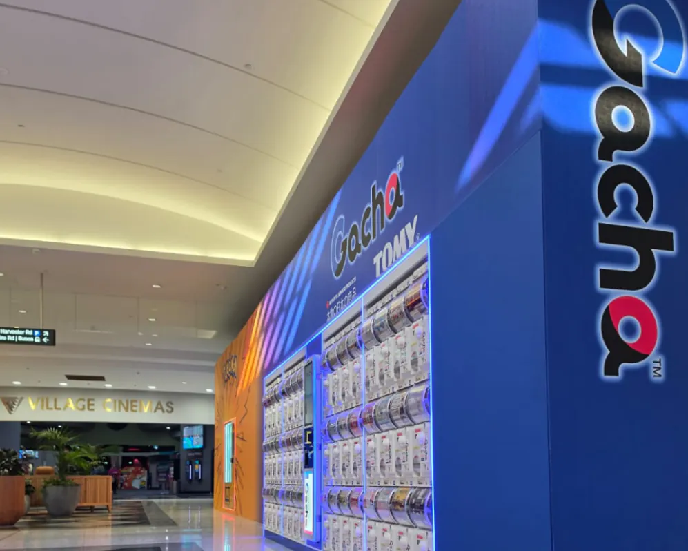Entrance of the Sunshine Marketplace Gacha store with capsule-toy machines lining both sides